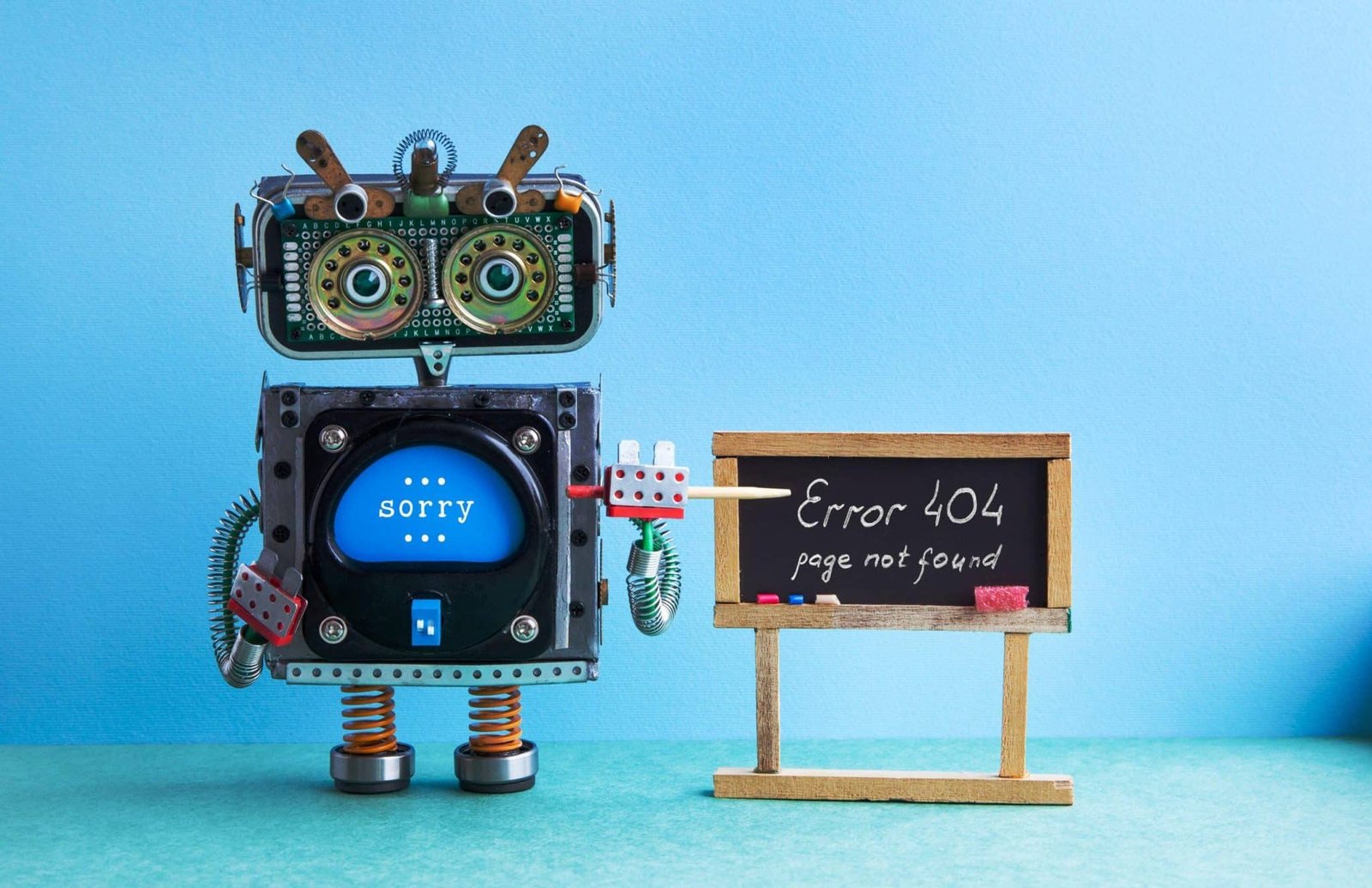 404 error page not found robot teacher with pointer black chalkboard handwritten error message green blue background classroom interior